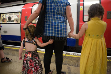 London  Grossbritannien  eine Mutter mit ihren beiden Toechtern in der U-Bahn