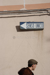 Oristano  Italien  ein Mann geht neben einem Einbahnschild SENSO UNICO vorbei