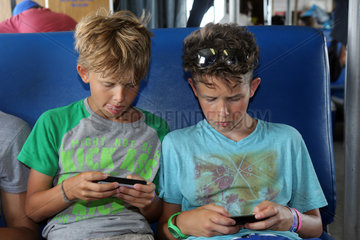 St. Pete Beach  USA  Jungen schauen auf ihre Smartphones