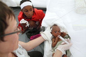 Carrefour  Haiti  Krankenschwester fuettert mit Hilfe einer Einwegspritze ein Kleinkind