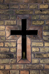Berlin  Deutschland  ein Kreuz in einer Mauer auf dem Friedhof am Suedstern
