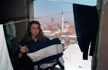 Sarajevo  Bosnien-Herzegowina  eine junge Frau haengt Waesche auf
