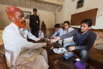 Hamzomahar  Pakistan  Mr. Hafiz nimmt Geld fuer seine Arbeiter entgegen