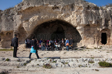 Syrakus  Italien  eine Reisegruppe macht Gruppenfotos vor Ruinen im Parco Archeologico della Neapoli