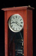Electric master clock of the half minute impulse type in mahogany case  c 1931.
