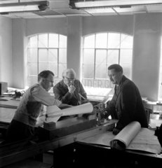 Group discuss munitions development  engineering company  Leeds  1953.