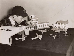 Boy with model airport  Selfridges  London  December 1936.
