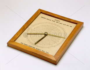 Combined circular and spiral slide rule  in a wooden frame  1882.
