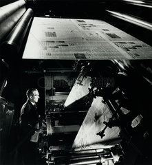 Printing newspapers: gate of machine from top with printer below  1956.