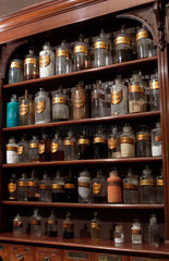 Shelves containing pharmaceutical bottles  late 19th early 20th century.