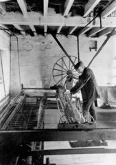 A Spinning Jenny in use at Palmer Mackay Limited  Trowbridge  c 1930.