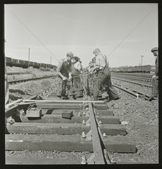 Railway worker removing track  1950.