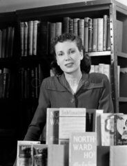 Portrait of a woman with a display of books  1950.