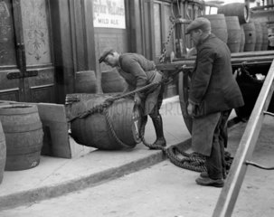 Draymen unloading barrels of beer  23 April