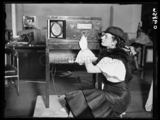 Woman inspecting an Atlas radio  Radiolympia  Olympia  London  1934.