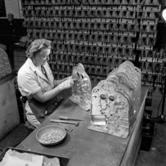 A female worker tests casings for Gestetner machines  1954.