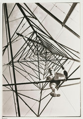Man climbing a pylon  c 1930.