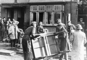 ARP men salvaging furniture from a damaged house  1941.