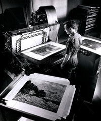 Operator cuts prints of impressionist paintings used in packing  1962.