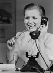 Woman answering a telephone  1955.