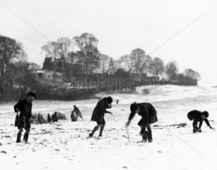 Schoolboys playing in the snow  c 1930s.