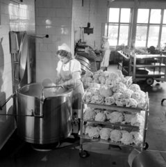 A cook prepares cauliflowers in the canteen at Montague Burton Menswear.