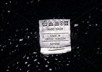 Clothing label showing washing instructions  c 1990s.