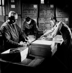 Three men at Lyle and Scott pack sweaters for export to Stockholm  1953.