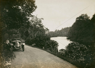 Motor car beside the River Dee  Wales  c 1912.