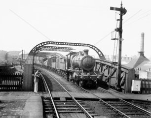 A railway photographer captures a steam