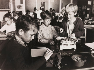 Children using an adding machine and balance  1967.