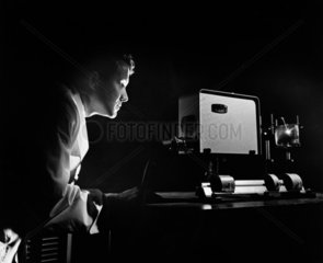 Telecommunications research engineer photographed by atmospheric lighting.