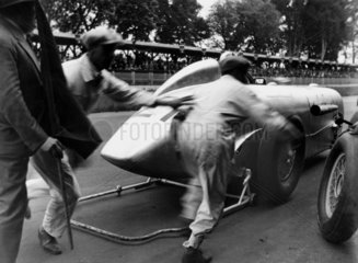 Mechanics running behind the 'Zeppelin on Wheels' SSK racing car  1932.