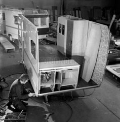 A worker fits out interior of caravan  innards show two tone effect .1968.