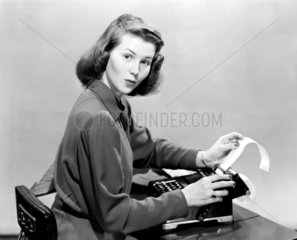 Woman using an adding machine  1950.