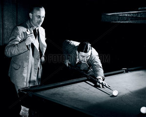 Playing billiards  c 1930s.