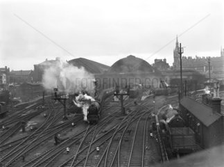 Steam locomotive and passenger train  King's Cross Station  London  c 1955.