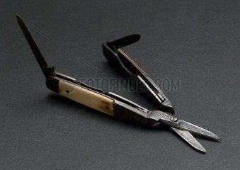 Pair of small scissors with folding knife blades. 19th century.
