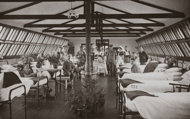 Nurses and wounded British soldiers in a hospital ward  1914-1918.