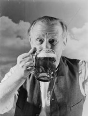 Man drinking a pint of beer  1952.