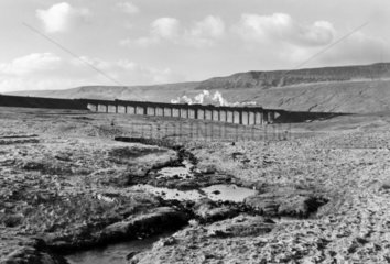 A goods train crossing the Ribblehead Viaduct  North Yorkshire  c 1950s.