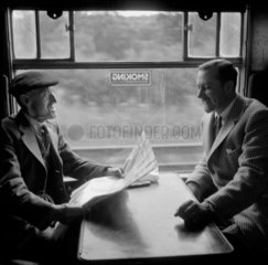 Old man talking to Colin Wills of the BBC during a train journey  1950.