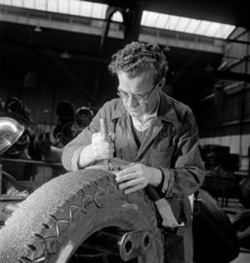 Applying new rubber and finishing with milled wheel at Tyresoles Ltd  1949.