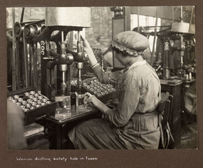 'Woman drilling safety hole in fuses'  1915-1918.