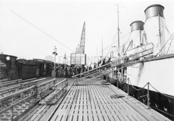 Passengers boarding a ferry  c 1918.