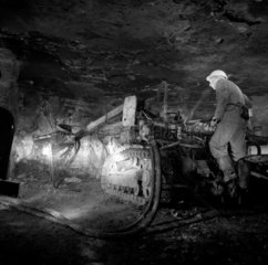 A man operates drilling machine  at the face of gypsum mine  Penrith  1974.