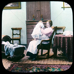 Woman and baby in rocking chair  c 1895.