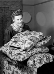 Woman carrying cushions  c 1948.