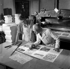 Inspector and worker in printing works examine company brochure  Bolton.