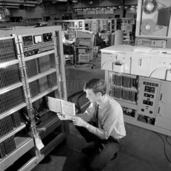 Engineers build computers on the assembly floor at Elliot Automation 1966.